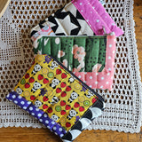 Pochette morbida recycled con impunture in cotone e similpelle, 3 fantasie